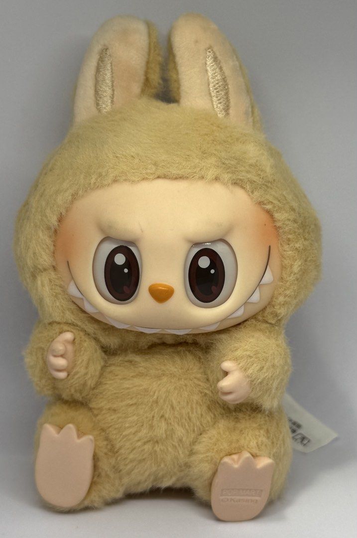 Pop Mart Labubu - Have a Seat - Baba (Category: Plushies & Soft Toys) located in Manila. Submitted by silverfalcon_dbc769 (Listing ID 1465727396, Image 1). Description: - Item: Pop Mart Labubu Plush Figure - Series: The Monsters - Exciting Macaron - Colorway: Sesame Bean - Design: Fluffy beige fur with a vinyl face, pointed teeth, and big dark eyes - Structure: Soft stuffed body in a sitting position with plastic hands and feet - Authenticity: In