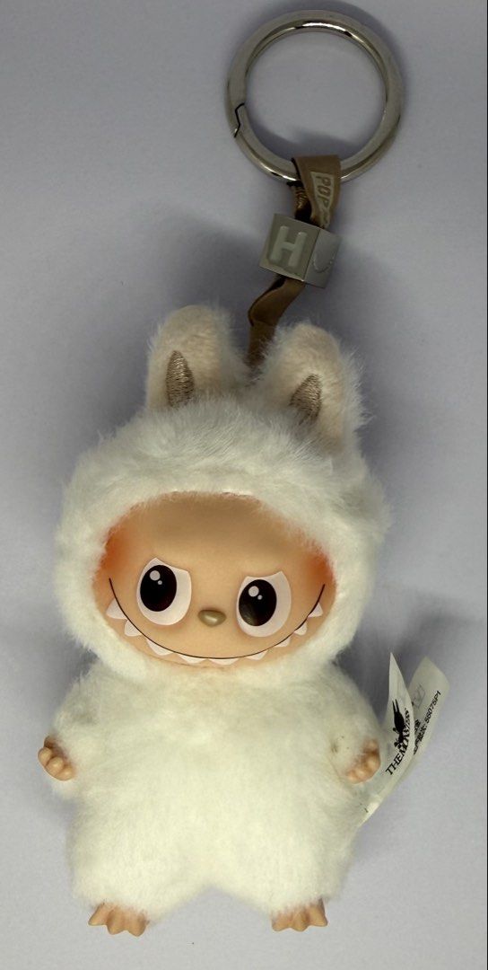 Pop Mart Labubu - Pin for Love - H (Category: Plushies & Soft Toys) located in Manila. Submitted by silverfalcon_dbc769 (Listing ID 1465721919, Image 1). Description: - Authentic Pop Mart Labubu The Monsters plush keychain in white - Features a soft furry texture, signature vinyl face with mischievous teeth, and small hands/feet - Equipped with a sturdy silver keyring, brown strap, and cute cube charm - Includes original drawstring dust bag and s