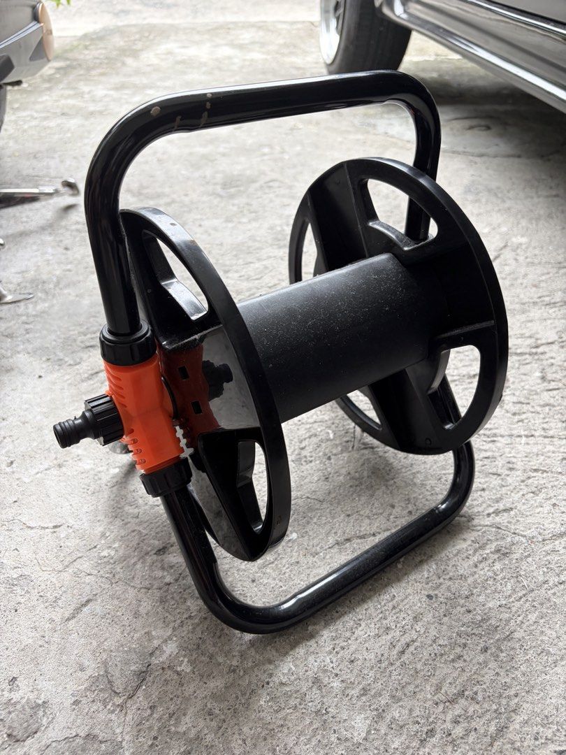 Portable Garden Hose Reel Holder Storage Stand (Category: Home Improvement Tools & Accessories) located in Manila. Submitted by finderskeepersmnl_092026 (Listing ID 1465645367, Image 2). Description: - Color: Black and orange - Sturdy metal frame built for daily outdoor use - Keeps your yard tidy and organized - Prevents kinks and extends hose life - Easy to wind and store.