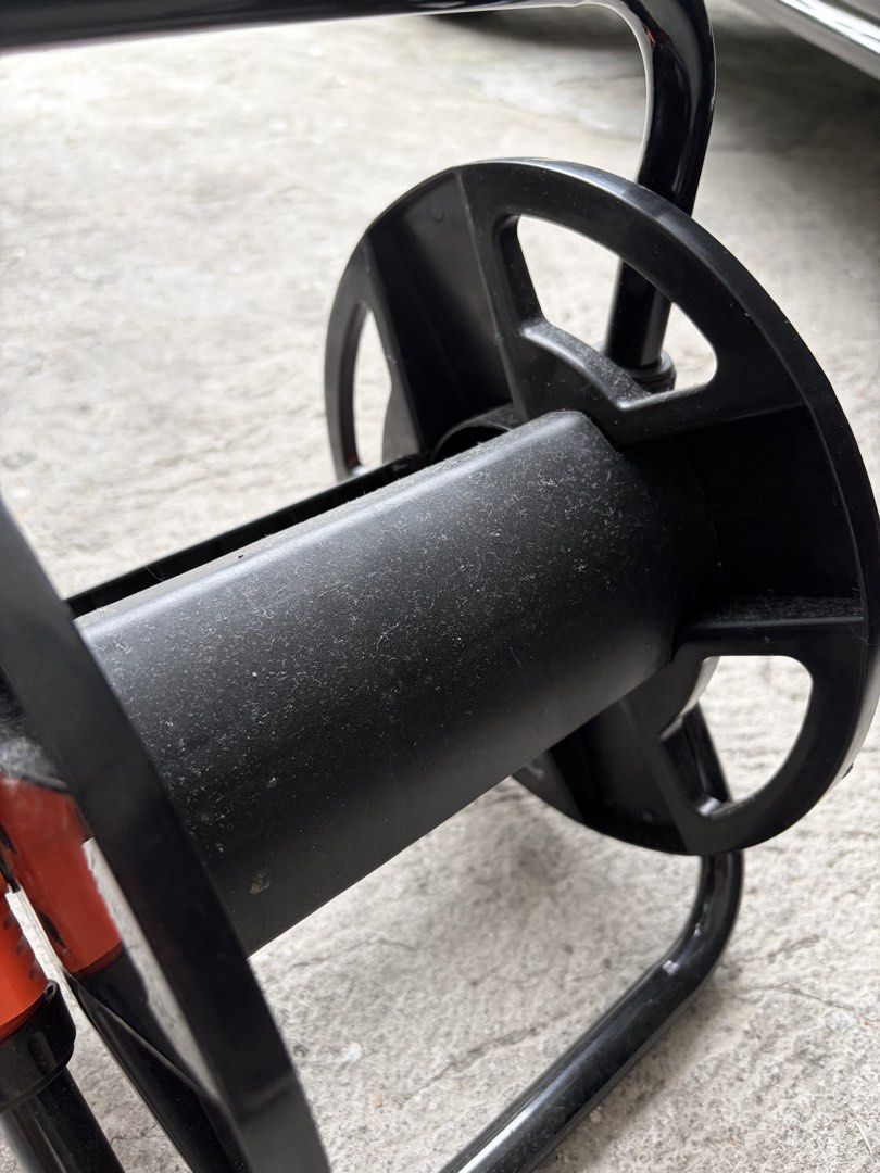 Portable Garden Hose Reel Holder Storage Stand (Category: Home Improvement Tools & Accessories) located in Manila. Submitted by finderskeepersmnl_092026 (Listing ID 1465645367, Image 3). Description: - Color: Black and orange - Sturdy metal frame built for daily outdoor use - Keeps your yard tidy and organized - Prevents kinks and extends hose life - Easy to wind and store.