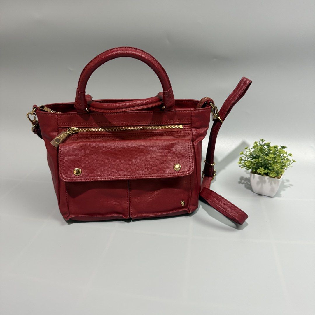 Porter internation two way sling (Category: Luxury Bags & Wallets) located in Bago City. Submitted by g___shop (Listing ID 1465689726, Image 1). Description: - Rich red textured faux leather structured handbag - Elegant gold hardware accents throughout - Secure top zip main closure with front zipper pocket and snap-flap compartment - Multiple exterior storage pockets for easy organization - Clean interior lining with handy slip pockets - Includes