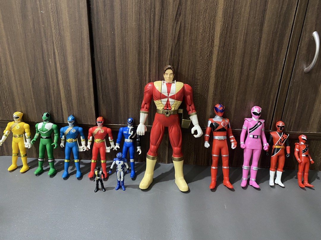 Power Rangers Action Figures (Category: Action & Battle Toys) located in Manila. Submitted by declutterthingzzz (Listing ID 1465707292, Image 2). Description: Collection of Power Rangers action figures in various sizes, colors, and series. Includes standard figures, mini figurines, and larger scale figures. Yellow, green, blue, red, pink, and black rangers represented. Some paint wear on figures from playing. Price varies on character and conditi
