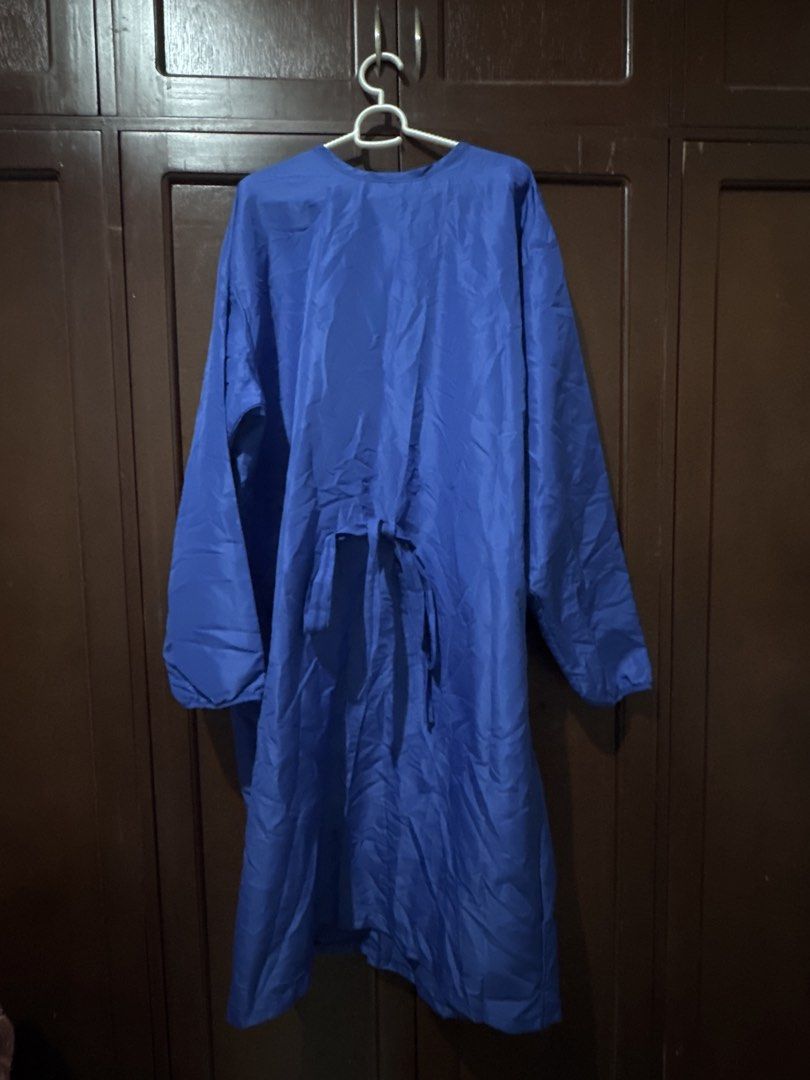 PPE Large (Category: Coats, Jackets and Outerwear) located in Cebu City. Submitted by kdlsstuff (Listing ID 1465608363, Image 1). Description: - Color: Solid royal blue - Material: Lightweight, breathable fabric - Design: Long sleeves with comfortable elastic cuffs - Closure: Secure tie closure at the back waist - Condition: Brand new, stored properly inside a wardrobe.