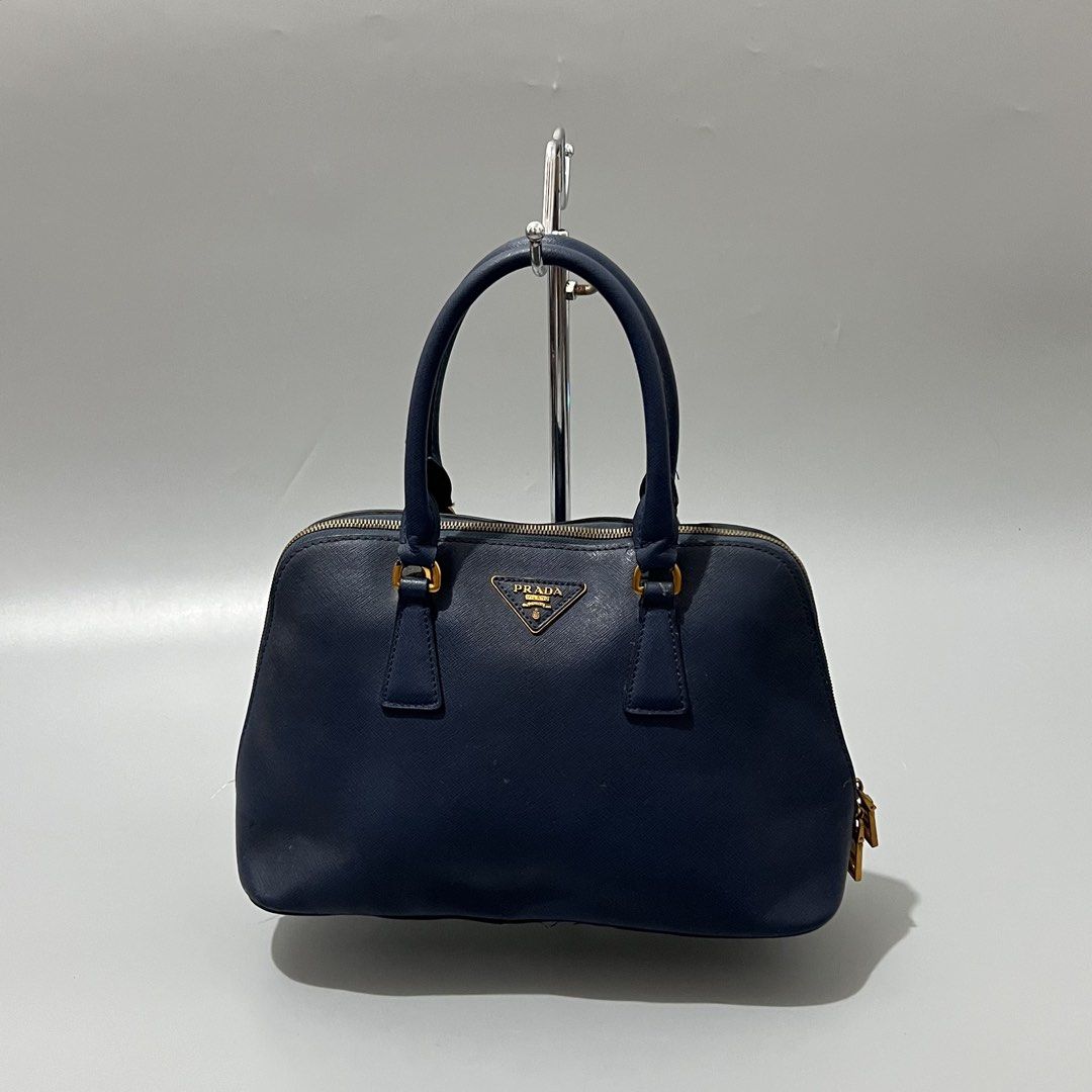 Prada - Saffiano - Dark Blue - leather (Category: Shoulder Bags) located in Cavite. Submitted by asianluxe (Listing ID 1465705681, Image 1). Description: Prada - Saffiano - Hand bag & shoulder - lethear Measurements Length:8.5 inches Width:15 inches Depth:5 inches Good condition Very presentable Sign of usage!.