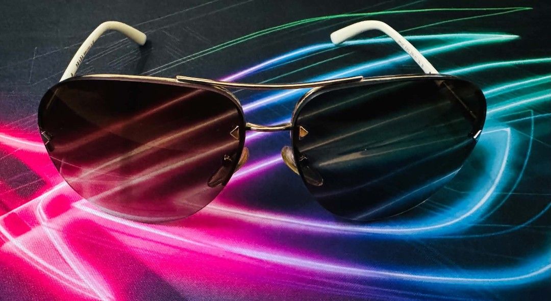 Prada Aviator Sunglasses with Case (Category: Sunglasses & Eyewear) located in Manila. Submitted by hyper_gamer (Listing ID 1465580682, Image 1). Description: - Authentic Prada aviator sunglasses made in Italy - Gold-tone metal frame with chic white temples - Gradient dark lenses offering classic pilot style - Lightweight construction for all-day comfort - Clean overall condition with minimal wear on the arms - Includes original black Saffiano le
