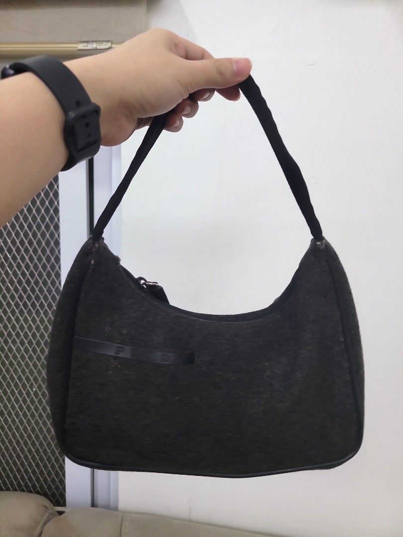 Prada Black Fabric Mini Shoulder Bag Pochette (Category: Luxury Bags & Wallets) located in Antipolo. Submitted by dlolin (Listing ID 1465741430, Image 1). Description: - Authentic Prada mini shoulder bag in classic black - Crafted from durable textured fabric with a fabric strap - Secure top zip closure for your belongings - Interior features the iconic Prada logo plaque - Compact size, perfect for daily essentials or evening events - Condition: 