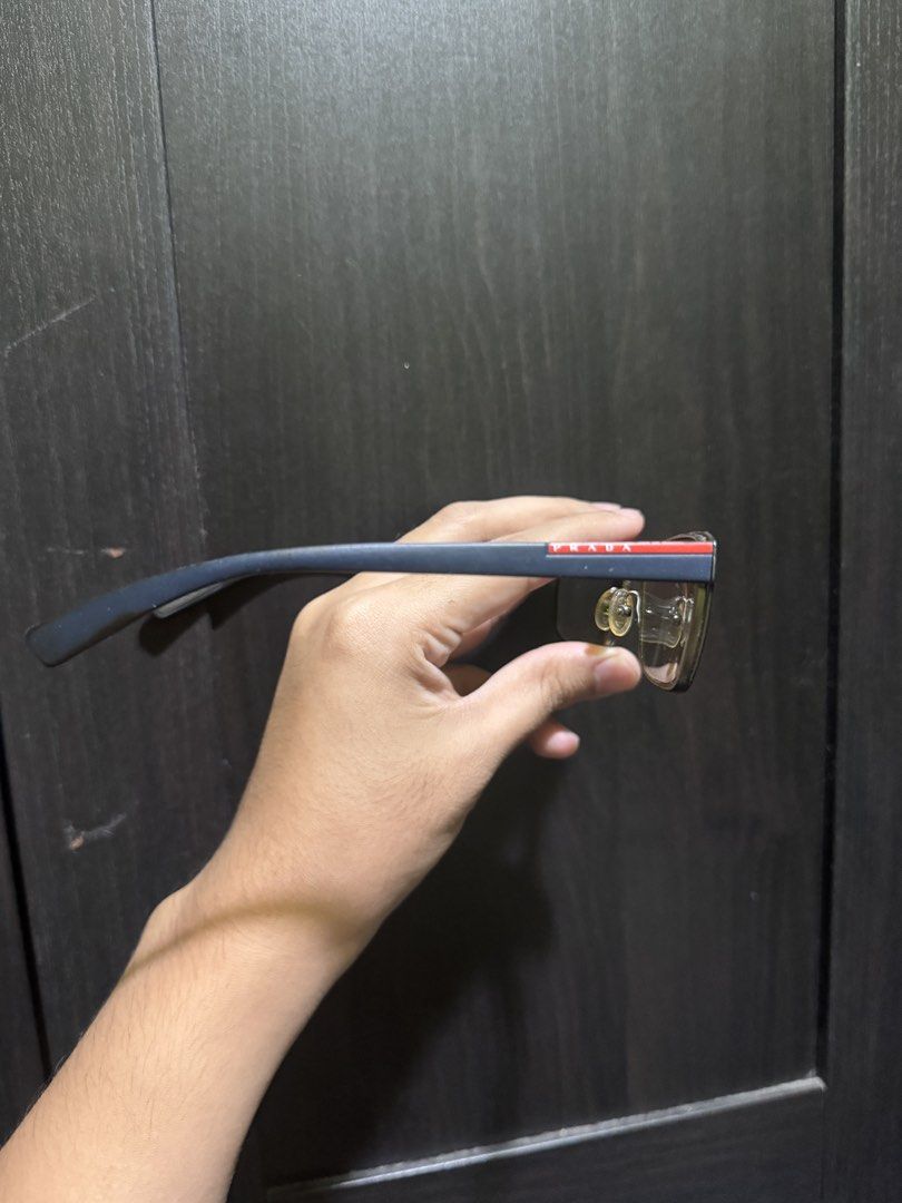 PRADA PS 50GV Blue Gradient (U6T1O1) (Category: Sunglasses & Eyewear) located in Manila. Submitted by pierce_120 (Listing ID 1465669474, Image 3). Description: - Authentic Prada designer eyeglasses in a stylish blue frame with red accent stripes on the temples - Made in Italy with CE certification - Equipped with clear prescription lenses and adjustable nose pads for all-day comfort - Includes original black Saffiano leather-texture hard case wit