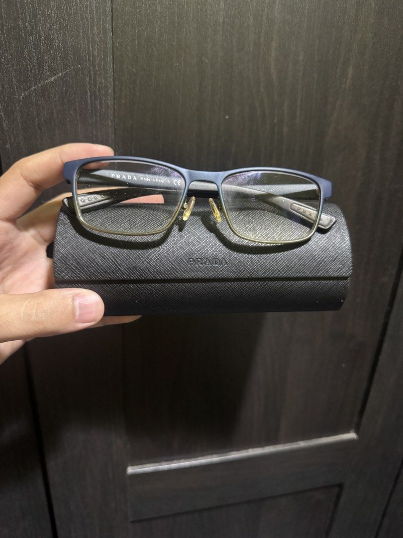 PRADA PS 50GV Blue Gradient (U6T1O1) (Category: Sunglasses & Eyewear) located in Manila. Submitted by pierce_120 (Listing ID 1465669474, Image 1). Description: - Authentic Prada designer eyeglasses in a stylish blue frame with red accent stripes on the temples - Made in Italy with CE certification - Equipped with clear prescription lenses and adjustable nose pads for all-day comfort - Includes original black Saffiano leather-texture hard case wit