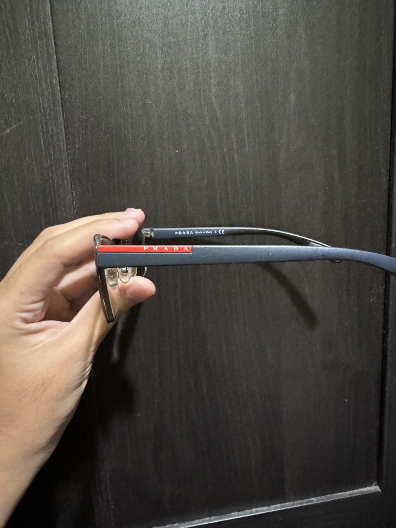 PRADA PS 50GV Blue Gradient (U6T1O1) (Category: Sunglasses & Eyewear) located in Manila. Submitted by pierce_120 (Listing ID 1465669474, Image 2). Description: - Authentic Prada designer eyeglasses in a stylish blue frame with red accent stripes on the temples - Made in Italy with CE certification - Equipped with clear prescription lenses and adjustable nose pads for all-day comfort - Includes original black Saffiano leather-texture hard case wit