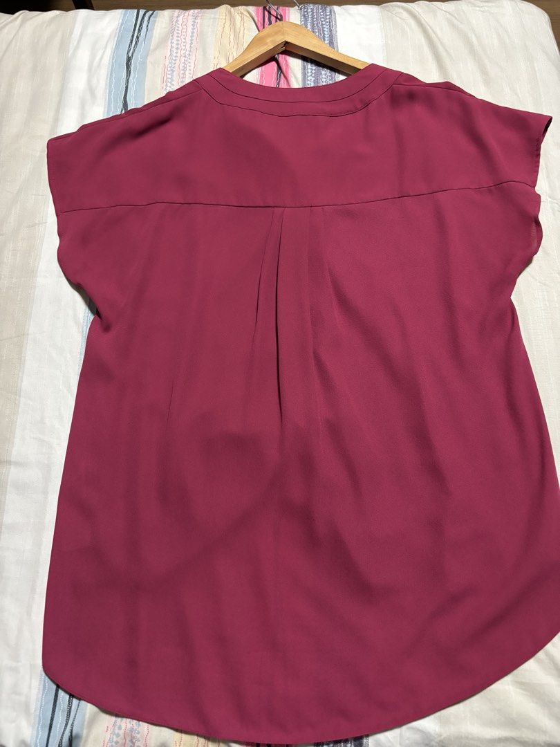 Principles by Ben de Lisi Maroon Blouse Size 14 (Category: Blouses) located in Quezon City. Submitted by declutter_incorporated (Listing ID 1465694155, Image 3). Description: - Brand/Label: Principles by Ben de Lisi - Size: 14 - Color: Maroon - Neckline: V-neck with split front placket - Sleeves: Short sleeves with gathered shoulder detail - Hem: Curved hem, slightly longer in the back - Back Details: Center inverted pleats on the back yoke - Fab