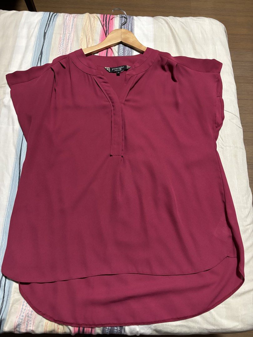 Principles by Ben de Lisi Maroon Blouse Size 14 (Category: Blouses) located in Quezon City. Submitted by declutter_incorporated (Listing ID 1465694155, Image 1). Description: - Brand/Label: Principles by Ben de Lisi - Size: 14 - Color: Maroon - Neckline: V-neck with split front placket - Sleeves: Short sleeves with gathered shoulder detail - Hem: Curved hem, slightly longer in the back - Back Details: Center inverted pleats on the back yoke - Fab
