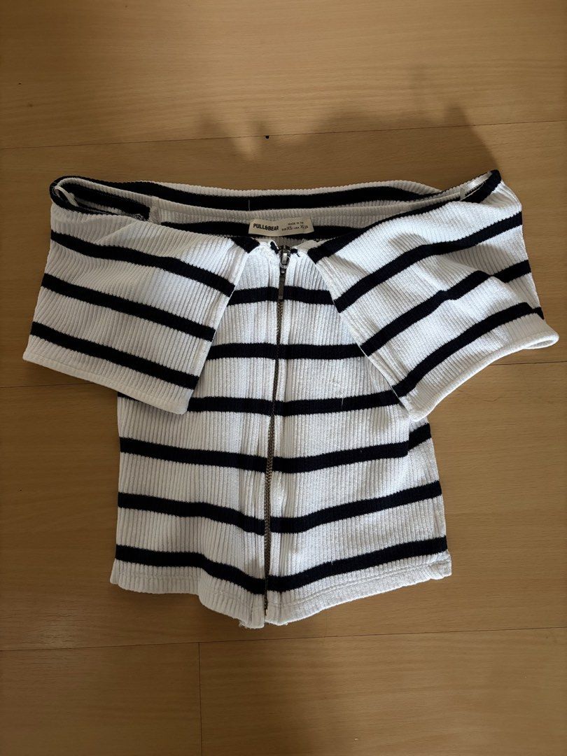 Pull&Bear Black and White Striped Off-Shoulder Zip Crop Top (Category: Blouses) located in Manila. Submitted by danni1_1 (Listing ID 1465621982, Image 1). Description: - Brand: Pull&Bear - Style: Black and white striped off-shoulder crop top with foldover collar and full front zipper - Material: Stretchy, snug ribbed knit fabric - Size: EUR XS / USA XS / MEX 24 - Condition: Great basic piece for everyday casual wear.