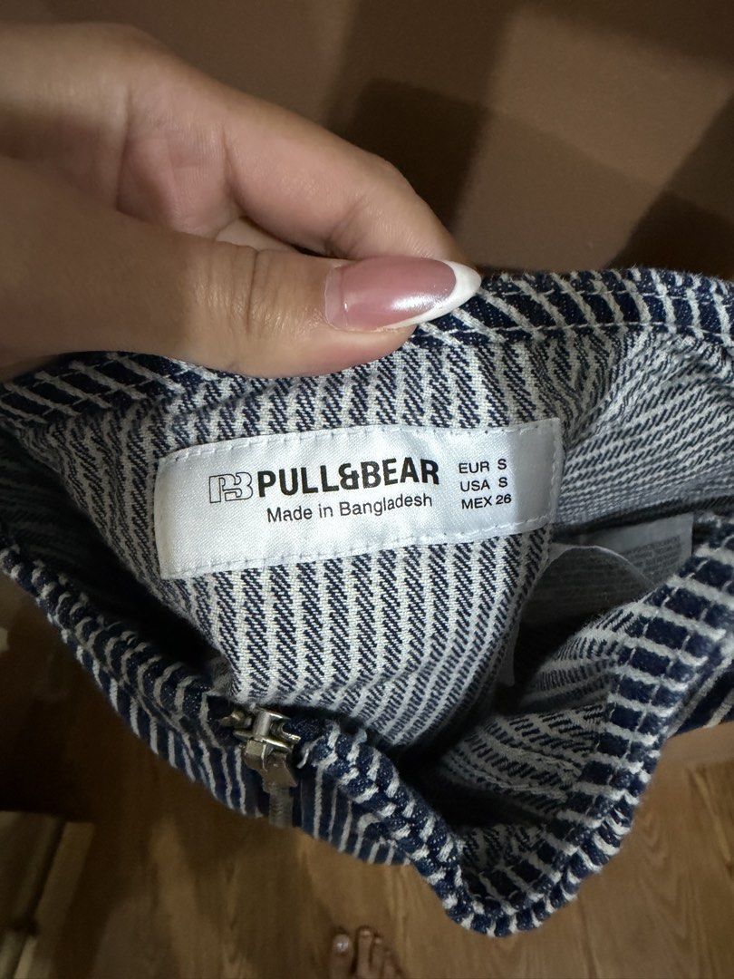Pull&Bear Blue and White Striped Crop Top Size S (Category: Sleeveless) located in Quezon City. Submitted by declutterbycy (Listing ID 1465758748, Image 2). Description: - Brand: Pull&Bear - Style: Blue and white striped crop top with full front zipper - Material: Structured denim-like fabric - Details: Thick shoulder straps and thin tie details at the back neck - Size: S (fits true) - Condition: Worn a few times, very good shape - Perfect casual