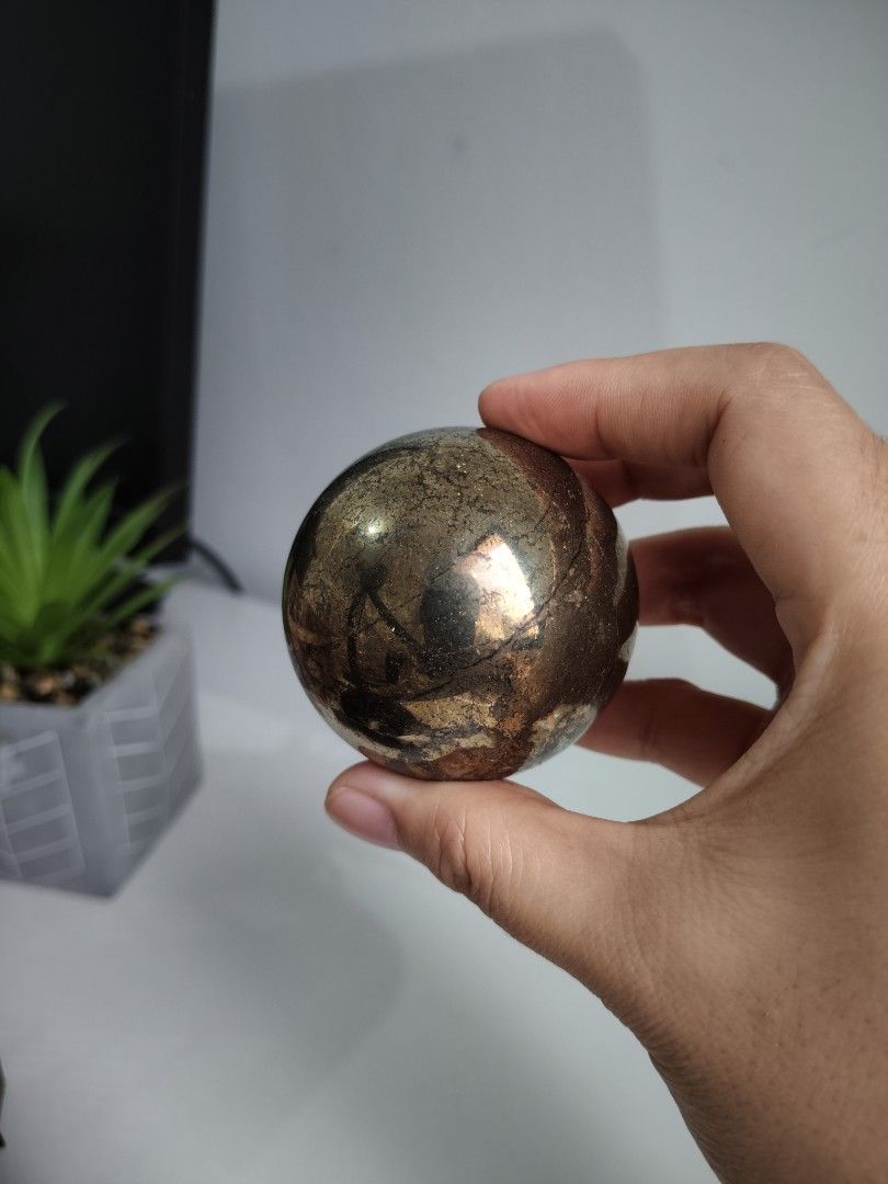 Pyrite Sphere Crystal Sphere (Category: Precious Stones) located in Cavite. Submitted by lynlcb (Listing ID 1465653080, Image 1). Description: - Polished pyrite sphere with stunning metallic gold and bronze sheen - Heavy in hand with unique natural matrix lines - Flawless polish with no chips or scratches - Perfect statement display piece for any desk or shelf - Carefully packed and ready for shipping - weight is 420g.