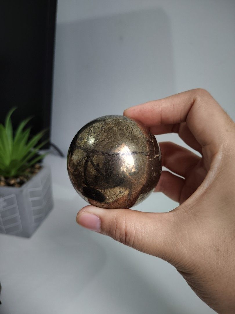 Pyrite Sphere Crystal Sphere (Category: Precious Stones) located in Cavite. Submitted by lynlcb (Listing ID 1465653080, Image 2). Description: - Polished pyrite sphere with stunning metallic gold and bronze sheen - Heavy in hand with unique natural matrix lines - Flawless polish with no chips or scratches - Perfect statement display piece for any desk or shelf - Carefully packed and ready for shipping - weight is 420g.