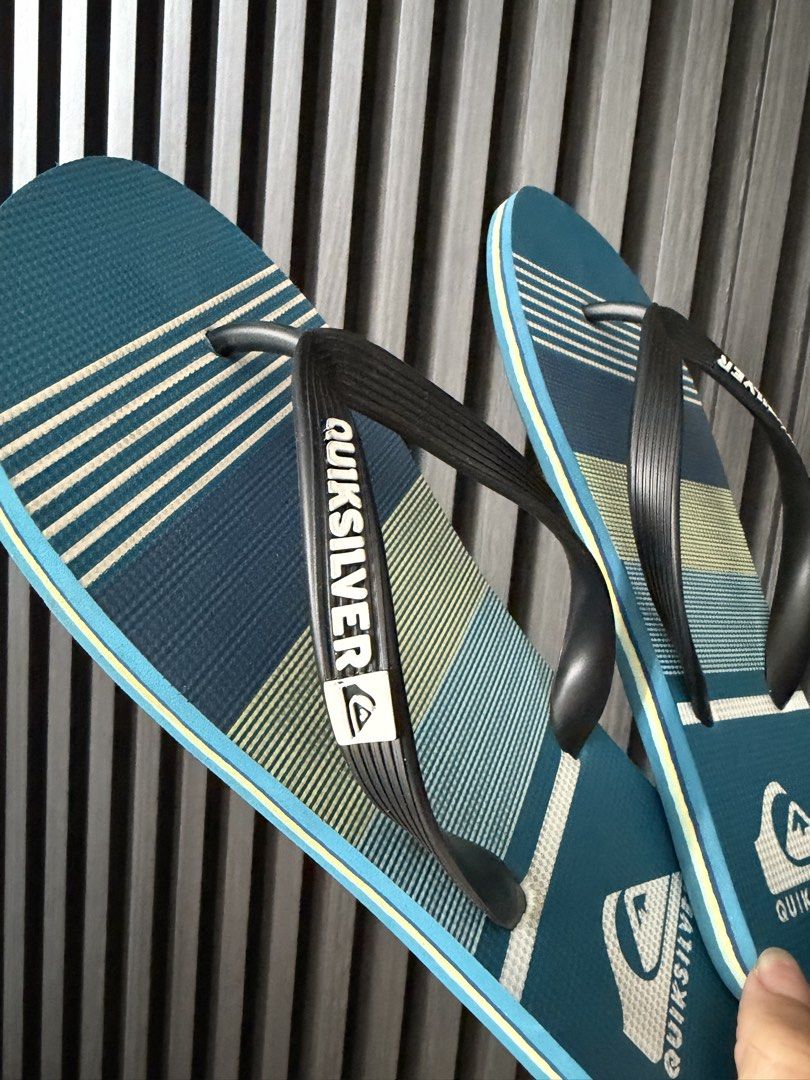 Quiksilver Blue Striped Flip-Flops Sandals (Category: Slippers & Slides) located in Manila. Submitted by purestar.01 (Listing ID 1465586819, Image 2). Description: - Brand: Quiksilver - Color: Blue with striped footbed and black straps - Features: Lightweight design, white Quiksilver strap branding, and textured grip soles - Condition: Clean with minimal wear - Best for: Beach trips, poolside, or casual everyday lounging.