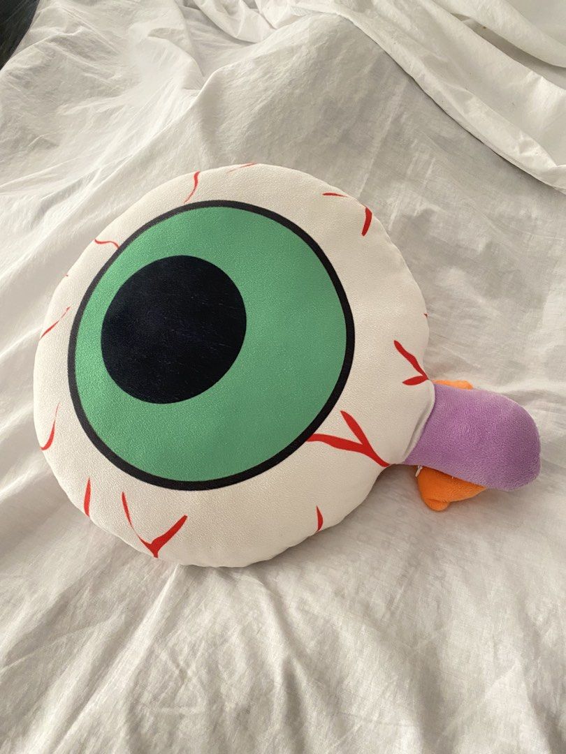 Quirky Eye Shape Plush Pillow (Category: Plushies & Soft Toys) located in Quezon City. Submitted by creesostomo (Listing ID 1465594410, Image 1). Description: - Design: Green and black eyeball with realistic red veins on a white background - Unique details: Features small purple and orange plush attachments on the side - Material: Made with ultra-soft fabric for maximum comfort - Usage: Perfect as a quirky room decor piece or a comfy couch cushio