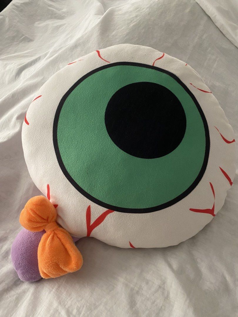 Quirky Eye Shape Plush Pillow (Category: Plushies & Soft Toys) located in Quezon City. Submitted by creesostomo (Listing ID 1465594410, Image 2). Description: - Design: Green and black eyeball with realistic red veins on a white background - Unique details: Features small purple and orange plush attachments on the side - Material: Made with ultra-soft fabric for maximum comfort - Usage: Perfect as a quirky room decor piece or a comfy couch cushio