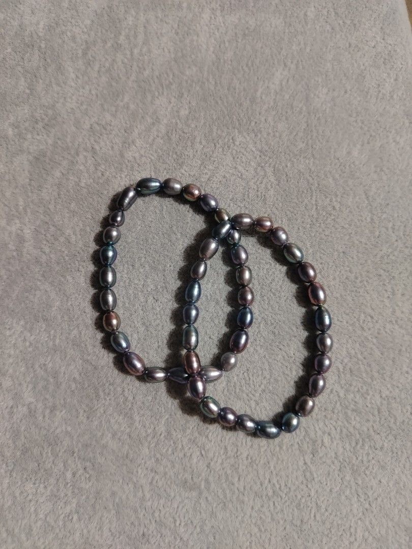 Real Tahitian Pearl Bracelets Set (Category: Bracelets) located in Manila. Submitted by whimsical.moon (Listing ID 1465752529, Image 1). Description: - Set of 2 matching bracelets - Dark iridescent oval pearls with purple and green peacock undertones - Stretchy inner cord for easy slip-on wear - Versatile design: wear stacked or separately - Adds a subtle, elegant shimmer to everyday outfits.