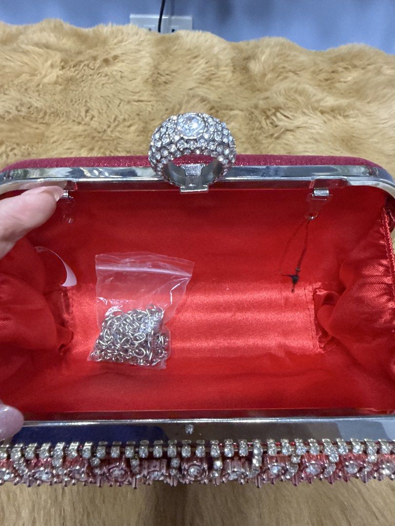 Red Rhinestone Evening Clutch Bag with Ring Clasp (Category: Clutches) located in Alaminos. Submitted by jhean1323 (Listing ID 1465584761, Image 3). Description: - Stunning red evening clutch with front rhinestones and glitter back - Secure and trendy ring clasp closure - Structured hard case design to keep your essentials safe - Clean red interior lining - Includes an optional chain strap (brand new in plastic) - Perfect for weddings, parties, a