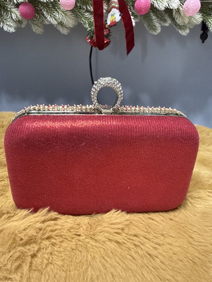 Red Rhinestone Evening Clutch Bag with Ring Clasp (Category: Clutches) located in Alaminos. Submitted by jhean1323 (Listing ID 1465584761, Image 2). Description: - Stunning red evening clutch with front rhinestones and glitter back - Secure and trendy ring clasp closure - Structured hard case design to keep your essentials safe - Clean red interior lining - Includes an optional chain strap (brand new in plastic) - Perfect for weddings, parties, a
