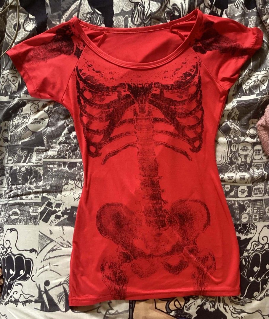Red skeleton x-ray graphic print t-shirt (Category: Tshirts & Polo Shirts ) located in Bulacan. Submitted by timeless_finds (Listing ID 1465698065, Image 1). Description: - Color: Red with black x-ray skeleton print (rib cage, spine, and pelvis) - Fit: Fitted cut with short sleeves and a scoop neckline - Material: Soft and comfortable fabric - Style: Alternative / grunge statement piece - Styling Tip: Great to pair with high-waisted jeans or skir