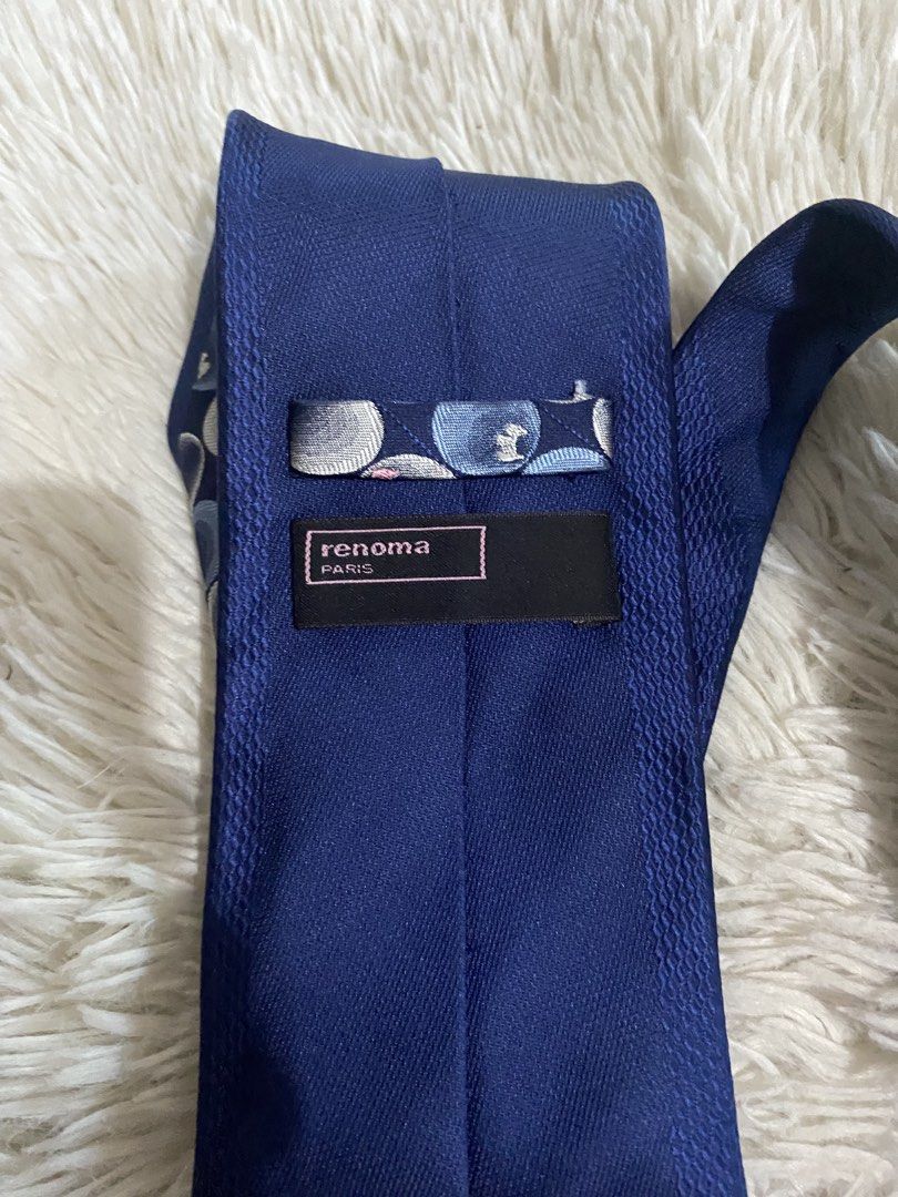 Renoma Paris Blue Patterned Tie (Category: Ties) located in Bulacan. Submitted by rich2545 (Listing ID 1465581182, Image 3). Description: - Brand: Renoma Paris - Color: Deep blue with blue, grey, white, and pink pattern - Design: Overlapping circles - Size: Standard width - Features: Blue keeper loop and branded back label - Condition: Clean and ready to wear for work or formal events.