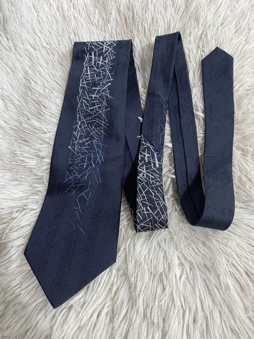 Renoma Paris Dark Blue Tie with Abstract Silver Pattern (Category: Ties) located in Bulacan. Submitted by rich2545 (Listing ID 1465581573, Image 1). Description: - Brand: Renoma Paris - Material: Premium Silk - Color/Design: Dark blue textured fabric with abstract silver and blue stick pattern - Fit: Standard width cut - Details: Includes branded loop and luxurious gold tipping cloth inside the tail - Condition: Excellent pre-loved condition - Pe