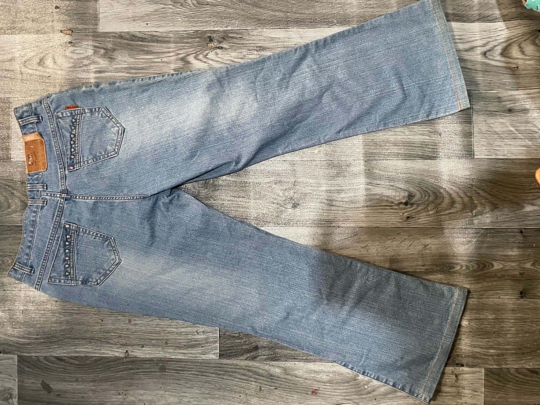 Rike Jean Studded Denim Jeans (Category: Jeans) located in Cagayan de Oro. Submitted by rhyrhyrhys (Listing ID 1465611825, Image 2). Description: - Brand: Rike Jean - Wash: Light wash - Fit: Straight leg - Details: Silver studs on front and back pockets, brown leather 'Rike Jeans Division' patch on the back waistband - Closure: Zip fly with button DIMES: L - 36.5 W - 30 HEM - 10 INSEAM - 27 F. RISE - 9.5 B. RISE - 12.5.