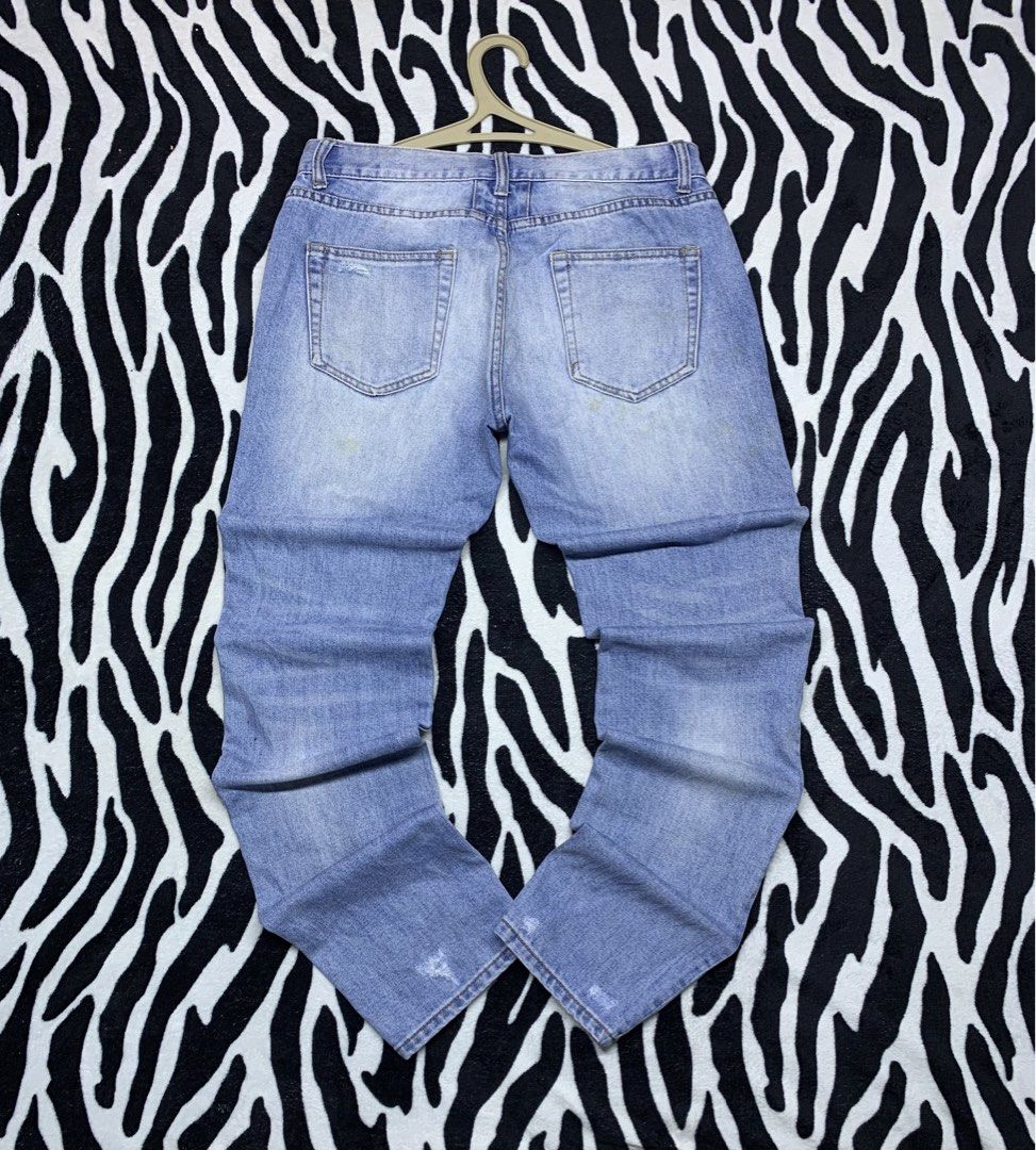 SAINT LAURENT PARIS TATTERED JEANS (Category: Jeans) located in Cagayan de Oro. Submitted by yooow.c (Listing ID 1465605324, Image 2). Description: W: 34 L: 41.5 THIGH: 12 HEM: 6.5 - good condition - have minor removable/washable yellow stain - tattered design - hard denim.