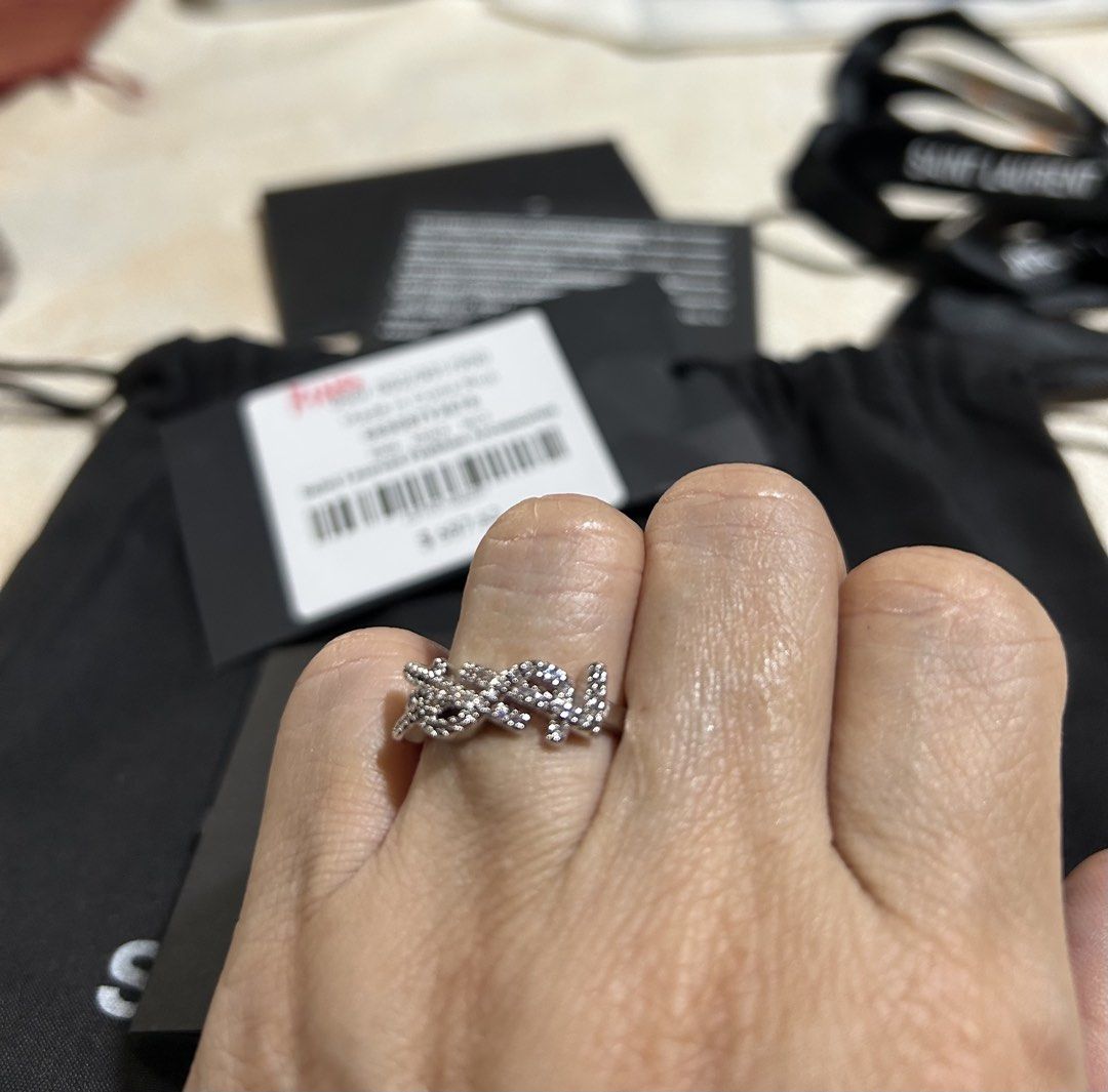 Saint Laurent YSL Pavé Monogram Ring (Category: Rings) located in Manila. Submitted by rosamanerds (Listing ID 1465605432, Image 2). Description: - Authentic Saint Laurent YSL pavé monogram ring in a sleek silver-tone finish - Features iconic interlaced YSL initials encrusted with sparkling crystals - Convenient adjustable open band design for a comfortable fit - Brand new and never worn, in pristine condition - Includes original retail tag showi