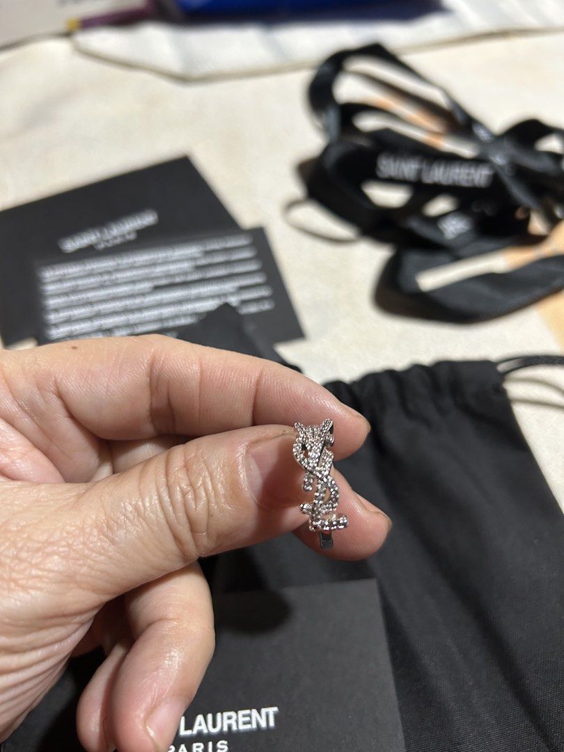 Saint Laurent YSL Pavé Monogram Ring (Category: Rings) located in Manila. Submitted by rosamanerds (Listing ID 1465605432, Image 1). Description: - Authentic Saint Laurent YSL pavé monogram ring in a sleek silver-tone finish - Features iconic interlaced YSL initials encrusted with sparkling crystals - Convenient adjustable open band design for a comfortable fit - Brand new and never worn, in pristine condition - Includes original retail tag showi
