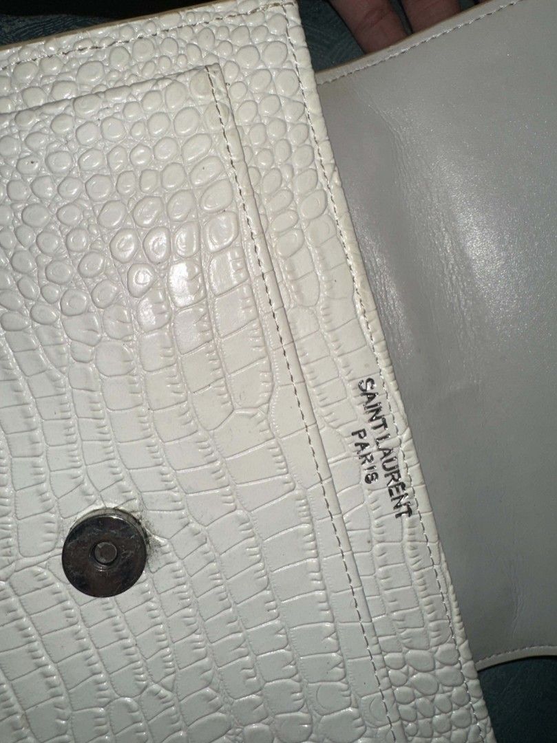Saint Laurent YSL White Crocodile Embossed Chain Bag (Category: Luxury Bags & Wallets) located in Batangas. Submitted by codexmark (Listing ID 1465649583, Image 3). Description: - Brand: Saint Laurent (YSL) - Material: White crocodile embossed leather - Hardware: Silver-tone with iconic YSL monogram logo - Closure: Secure magnetic snap closure - Interior: Fabric-lined with multiple compartments and a branded slip pocket - Strap: Elegant chain str