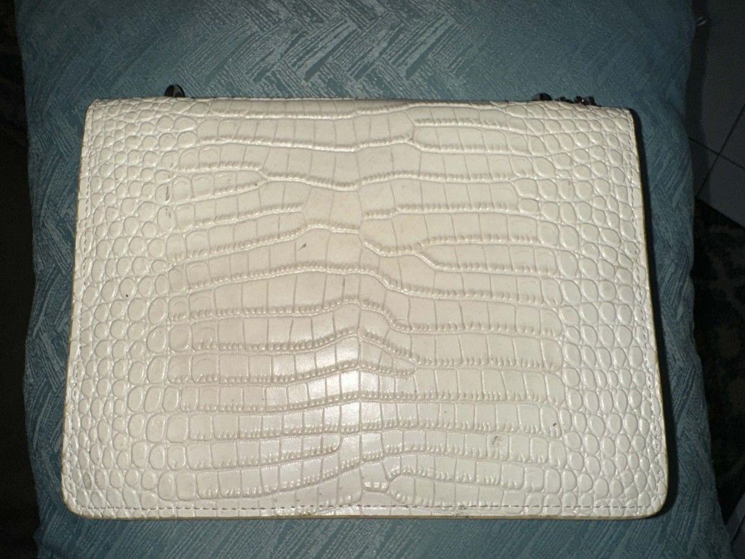 Saint Laurent YSL White Crocodile Embossed Chain Bag (Category: Luxury Bags & Wallets) located in Batangas. Submitted by codexmark (Listing ID 1465649583, Image 2). Description: - Brand: Saint Laurent (YSL) - Material: White crocodile embossed leather - Hardware: Silver-tone with iconic YSL monogram logo - Closure: Secure magnetic snap closure - Interior: Fabric-lined with multiple compartments and a branded slip pocket - Strap: Elegant chain str