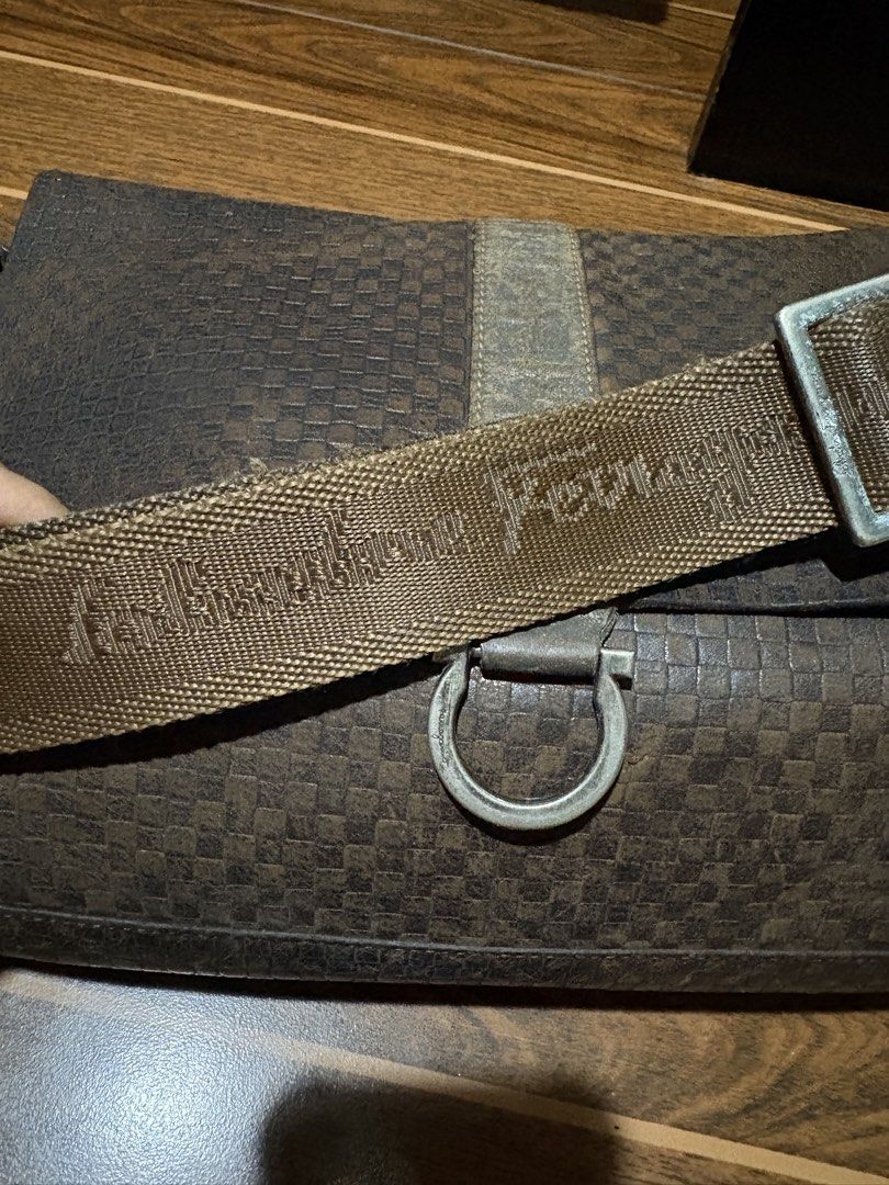 Salvatore Ferragamo Brown Checkered Messenger Bag (Category: Luxury Bags & Wallets) located in Bulacan. Submitted by love2loved (Listing ID 1465672062, Image 3). Description: Brown checkered messenger bag by Salvatore Ferragamo. Textured leather body with a sturdy canvas strap featuring the brand name. Magnetic front closure with a metal ring detail. Extra zippered compartment on the back flap. Roomy interior, great everyday carryall for daily co