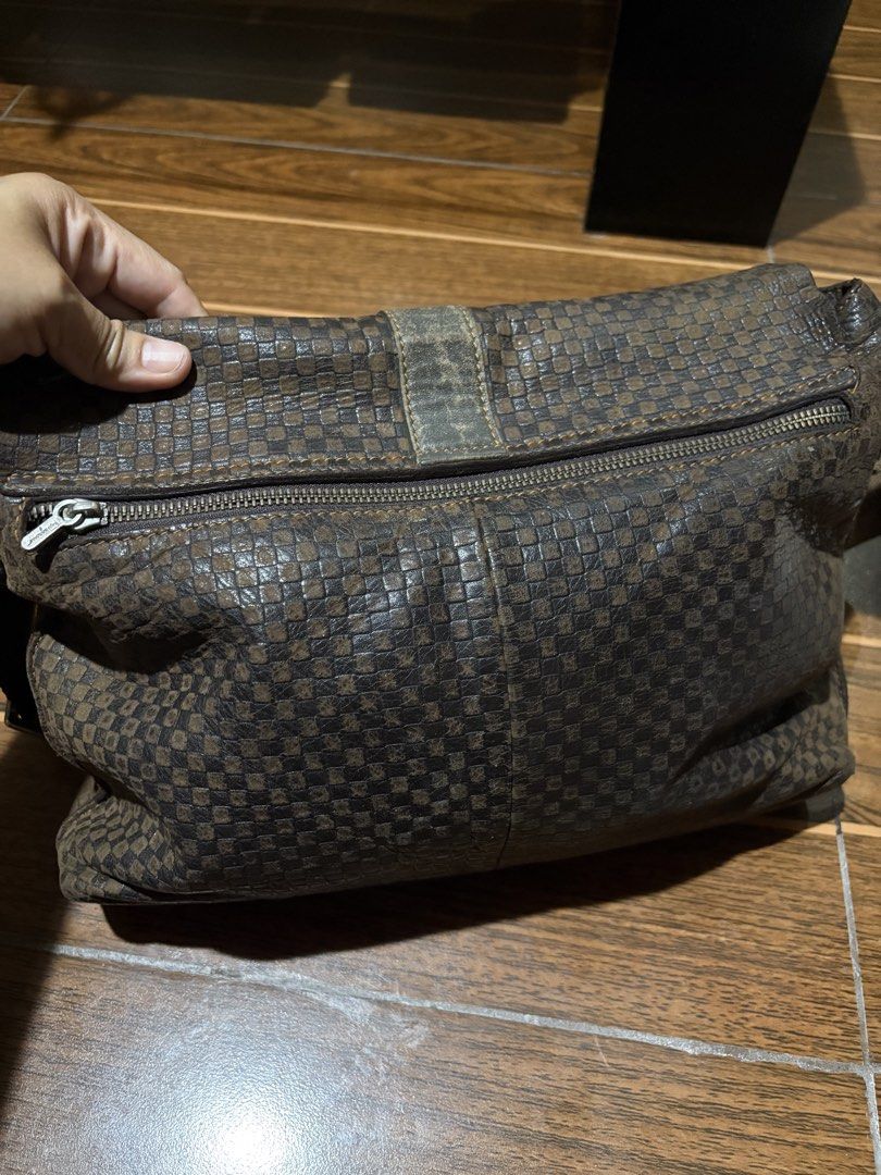 Salvatore Ferragamo Brown Checkered Messenger Bag (Category: Luxury Bags & Wallets) located in Bulacan. Submitted by love2loved (Listing ID 1465672062, Image 2). Description: Brown checkered messenger bag by Salvatore Ferragamo. Textured leather body with a sturdy canvas strap featuring the brand name. Magnetic front closure with a metal ring detail. Extra zippered compartment on the back flap. Roomy interior, great everyday carryall for daily co