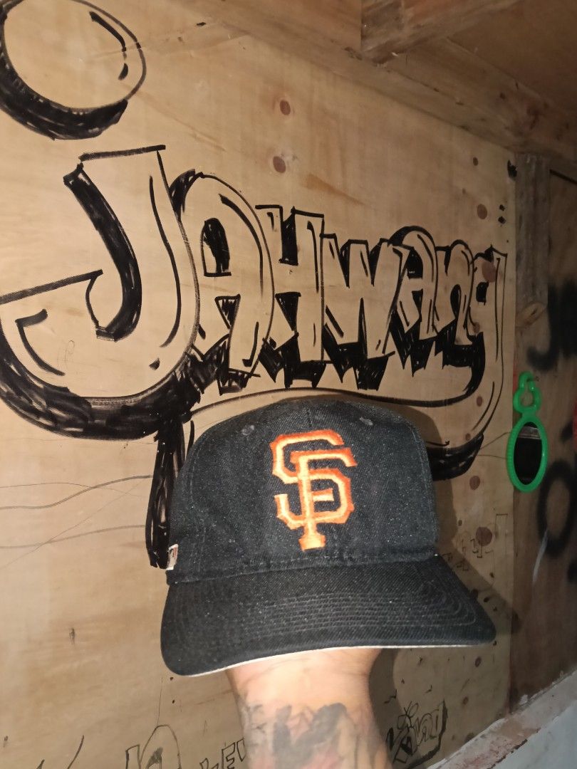 San Francisco Giants MLB Denim Cap (Category: Caps & Hats) located in Manila. Submitted by jahwang1973 (Listing ID 1465610458, Image 1). Description: - Brand: Sports - Team: San Francisco Giants - Material/Style: Dark denim body with classic orange embroidered SF logo - Brim: White underbrim with stitching details - Details: Small MLB batterman logo tag on the side - Condition: Clean exterior; interior white lining and sweatband show some yellowi