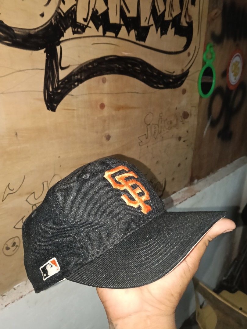 San Francisco Giants MLB Denim Cap (Category: Caps & Hats) located in Manila. Submitted by jahwang1973 (Listing ID 1465610458, Image 3). Description: - Brand: Sports - Team: San Francisco Giants - Material/Style: Dark denim body with classic orange embroidered SF logo - Brim: White underbrim with stitching details - Details: Small MLB batterman logo tag on the side - Condition: Clean exterior; interior white lining and sweatband show some yellowi