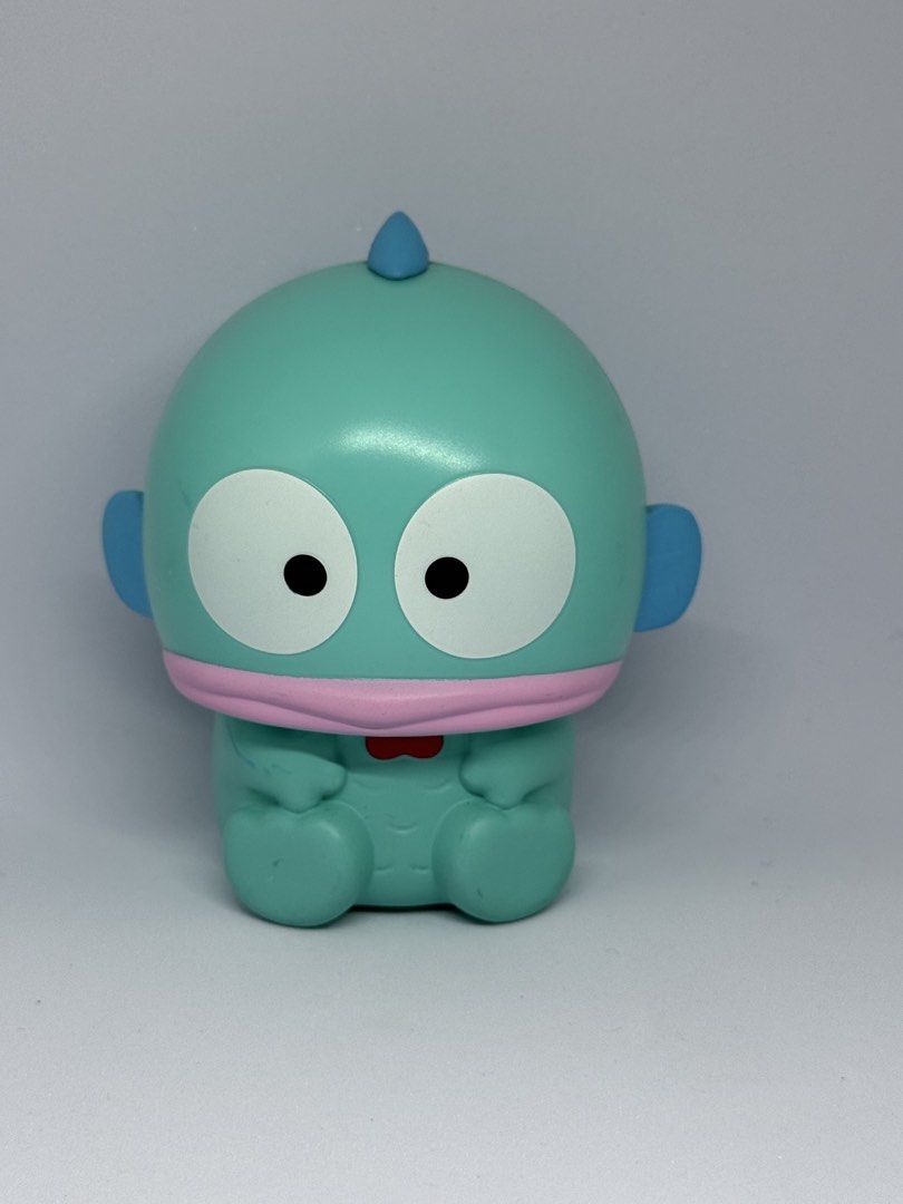 Sanrio Hangyodon Plush Charm and Figure Set (Category: Plushies & Soft Toys) located in Manila. Submitted by silverfalcon_dbc769 (Listing ID 1465749772, Image 3). Description: - Authentic Sanrio Hangyodon merchandise bundle (selling as a set) - Includes plush toy tucked inside a fluffy brown nest pouch with tag attached and an orange strap - Includes a cute turquoise plastic Hangyodon figure with detailed blue fins - Character features: iconic bl