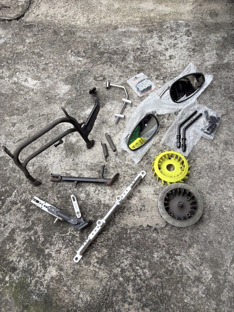 Scooter parts bundle stands mirrors cooling fan variator rollers (Category: Everything Else Others) located in Manila. Submitted by finderskeepersmnl_092026 (Listing ID 1465701843, Image 2). Description: - Scooter parts bundle (selling as one complete lot) - Includes center stand and side stand - Aftermarket mirrors included - Yellow and grey cooling fans - Roller weights package - Metal brackets and springs - Mixed condition, pulled from a scoot