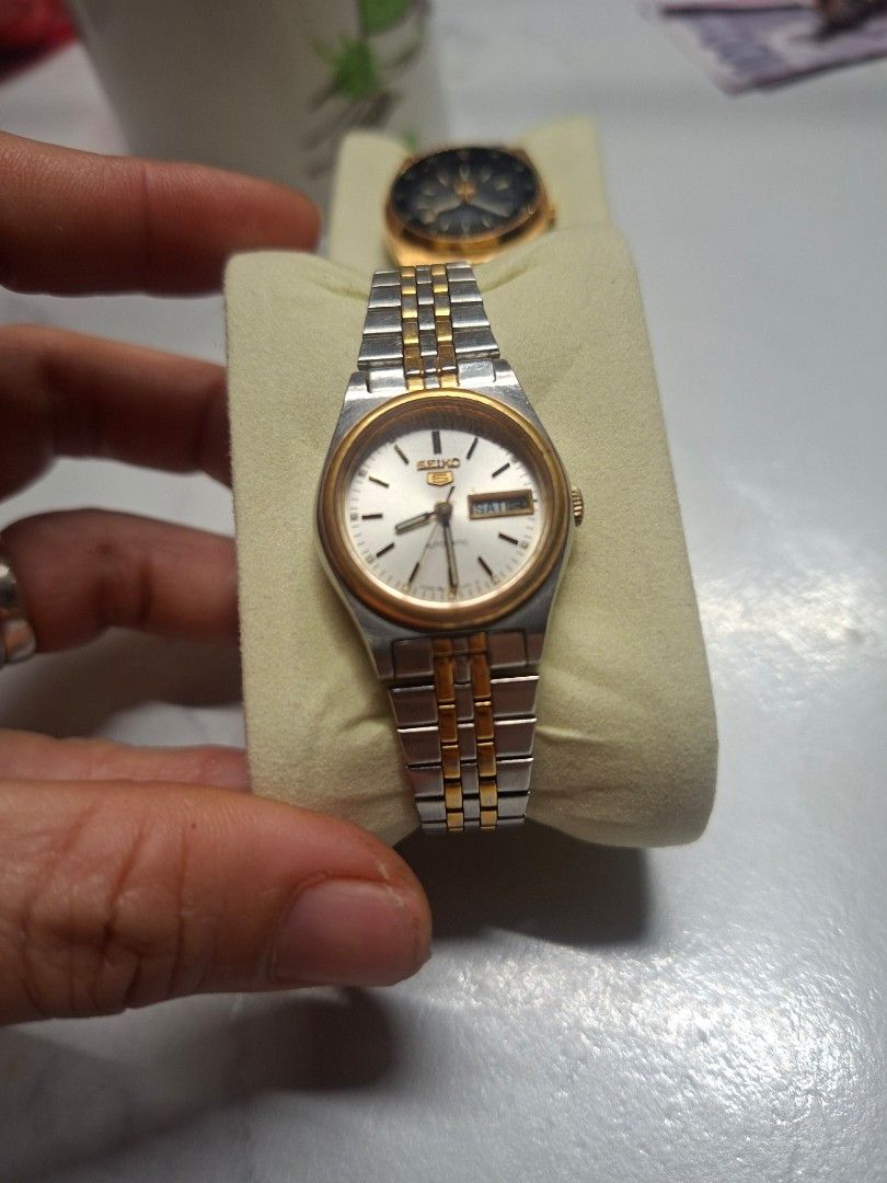 Seiko 5 Automatic Watch Two-Tone and Gold Pair (Category: Men's Watches) located in Manila. Submitted by jhennapollo_11 (Listing ID 1465720065, Image 2). Description: - Bundle of 2 classic vintage Seiko 5 automatic watches - Watch 1: Two-tone steel and gold bracelet, silver dial, and gold bezel - Watch 2: Gold-tone case and bracelet with black inner dial and 24-hour markers - Both feature convenient day-date display at the 3 o'clock position - Po