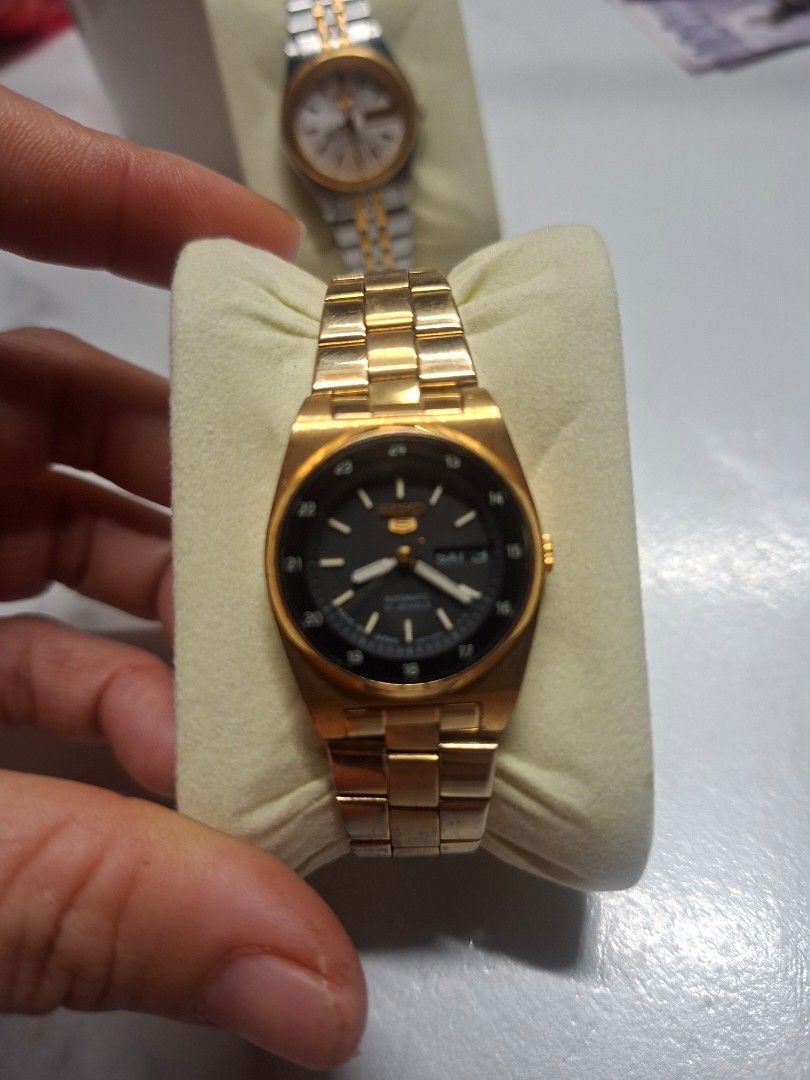Seiko 5 Automatic Watch Two-Tone and Gold Pair (Category: Men's Watches) located in Manila. Submitted by jhennapollo_11 (Listing ID 1465720065, Image 3). Description: - Bundle of 2 classic vintage Seiko 5 automatic watches - Watch 1: Two-tone steel and gold bracelet, silver dial, and gold bezel - Watch 2: Gold-tone case and bracelet with black inner dial and 24-hour markers - Both feature convenient day-date display at the 3 o'clock position - Po