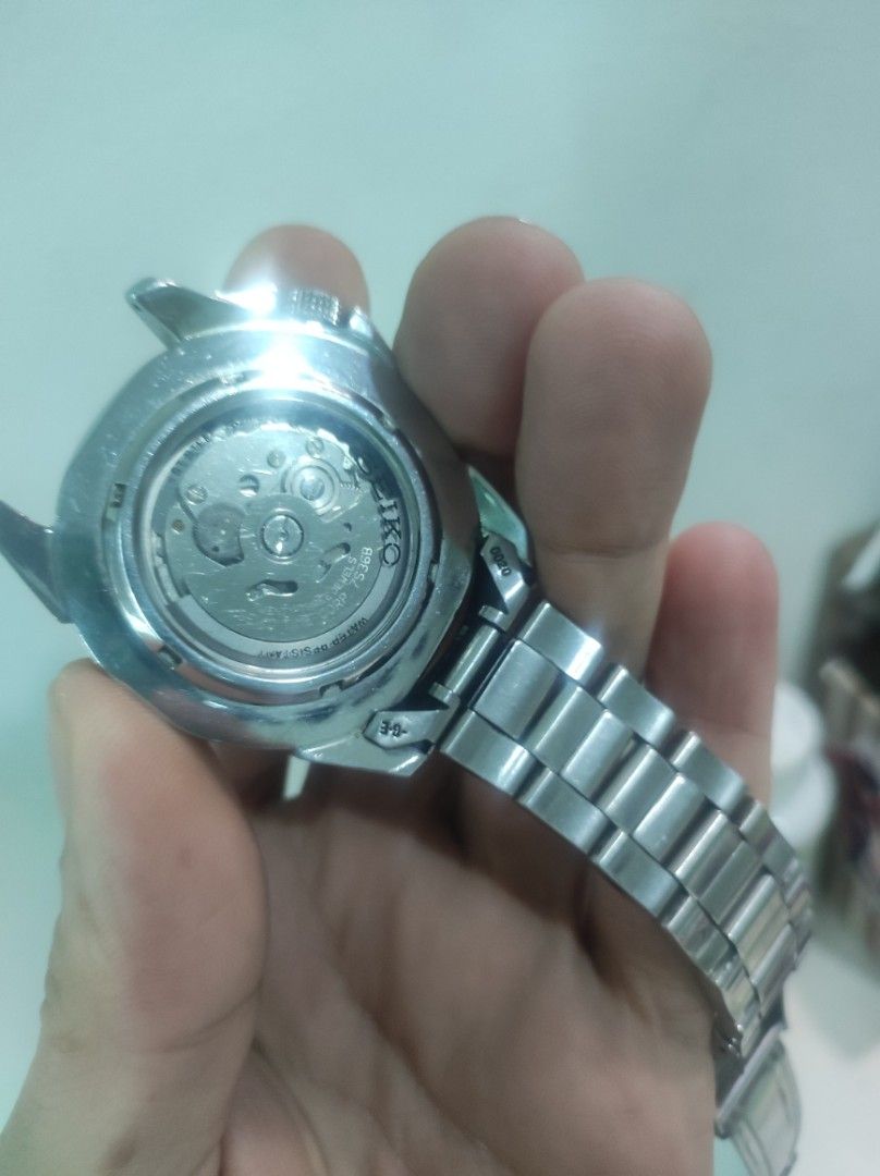 Seiko 5 Sports Automatic Compass Bezel Watch (Category: Men's Watches) located in Pasay City. Submitted by wizemindz138970 (Listing ID 1465647828, Image 3). Description: - Brand: Seiko 5 Sports Automatic Watch - Dial: White textured dial with day-date window at 3 o'clock - Movement: 23 jewels automatic movement with exhibition case back - Build: Stainless steel case and matching bracelet - Features: Rotating compass bezel and bright luminous hand