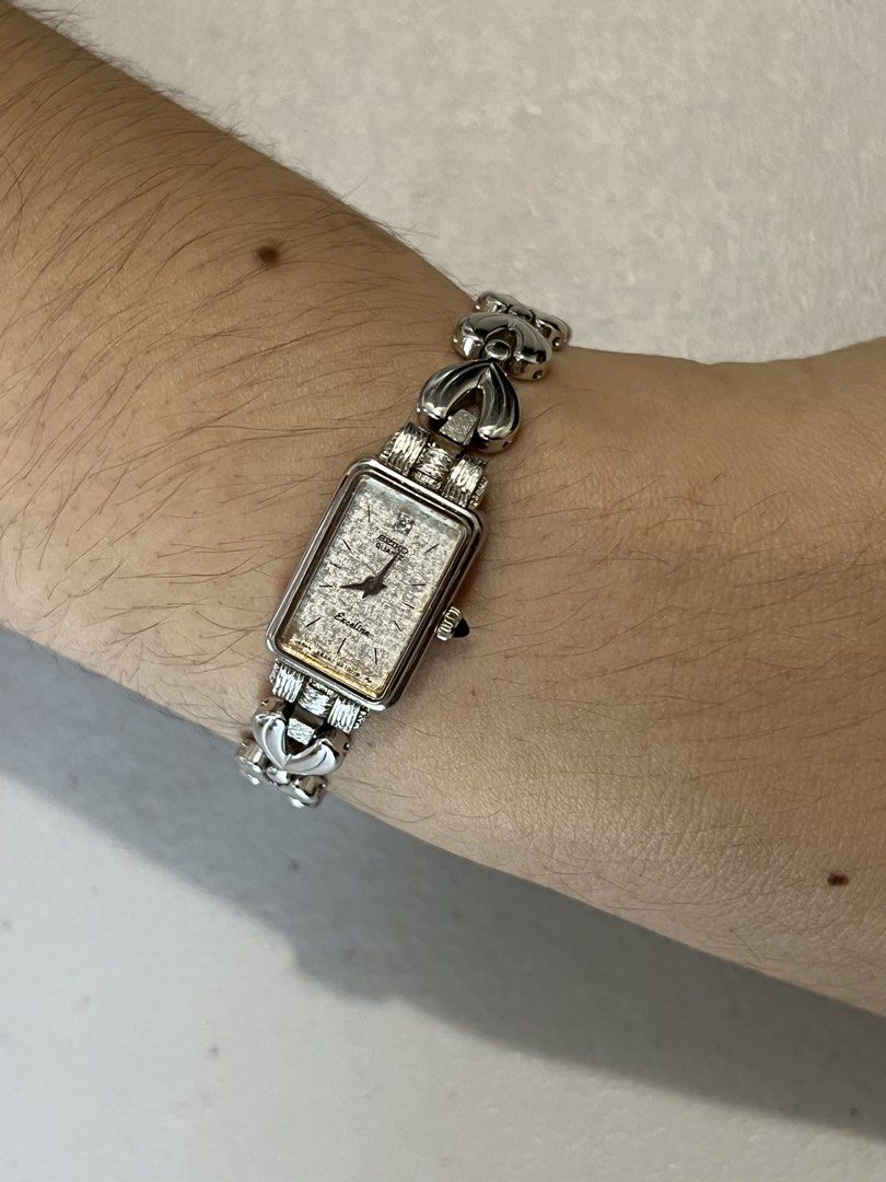 Seiko Exceline Tank Silver Dial Quartz – Ref. 2E20-5180 (Category: Women's Watches) located in Quezon City. Submitted by bobby.brown. (Listing ID 1465582871, Image 3). Description: Seiko Exceline Tank Silver Dial Quartz – Ref. 2E20-5180 Estimated BMBY: September 1994 An exceptionally dainty tank dress watch from Seiko’s premium Exceline line, featuring a slender rectangular silver-tone case framing a textured silver dial with minimal baton indice