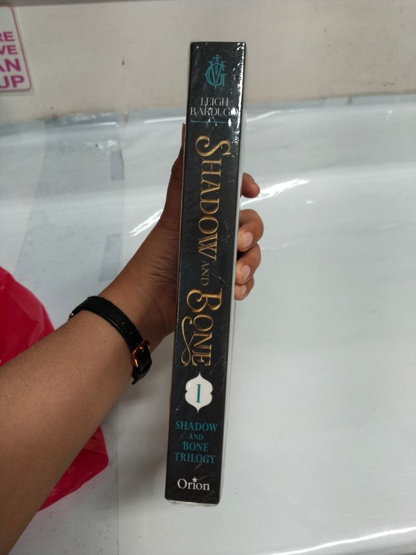 Shadow and Bone by Leigh Bardugo Paperback (Category: Storybooks) located in Taguig. Submitted by jener.498 (Listing ID 1465707045, Image 2). Description: - Title: Shadow and Bone by Leigh Bardugo - Series: Book 1 of the Shadow and Bone Trilogy (Grishaverse) - Edition: Orion paperback - Condition: Brand new, still sealed in original plastic shrink wrap - Genre: Young adult fantasy.