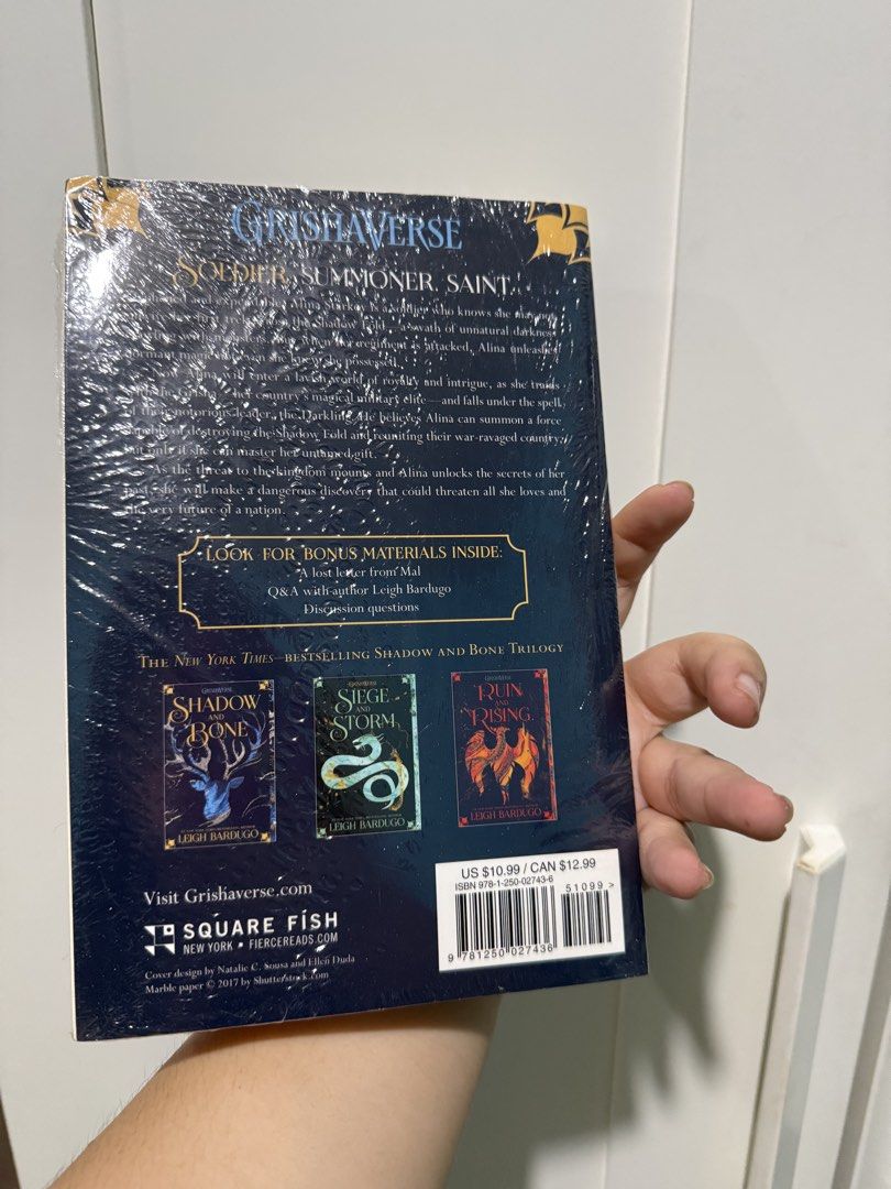 Shadow and Bone by Leigh Bardugo (BRAND NEW) (Category: Storybooks) located in Manila. Submitted by deanise_jil (Listing ID 1465735295, Image 2). Description: - Title: Shadow and Bone by Leigh Bardugo (Book 1 of the Grishaverse series) - Edition: Square Fish paperback with Netflix original series cover sticker - Condition: Brand new, still sealed tightly in original plastic wrapping (mild yellowing on pages/edges due to storage) - Extras: Include