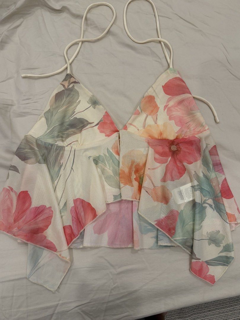 SHEIN Floral Print Halter Mesh Top (Category: Sleeveless) located in Calamba. Submitted by miss.ksnap (Listing ID 1465646408, Image 1). Description: - Brand: SHEIN - Style: Halter top with asymmetrical hem - Pattern: Colorful all-over floral print - Material: Sheer mesh (super lightweight and flowy) - Size: M - Condition: Worn once for a quick photo, practically brand new - Features: Ties securely behind the neck.