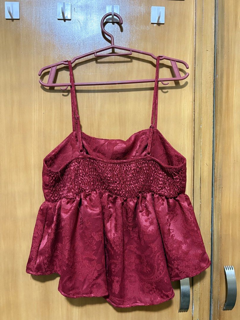 Shein MOD Red Top (Category: Sleeveless) located in Mandaue City. Submitted by klosetfindscebu (Listing ID 1465654277, Image 2). Description: - Color: Burgundy Red - Design: Textured floral damask pattern with flared peplum hem - Fit: Adjustable thin spaghetti straps and smocked elastic back panel for easy stretch - Styling: Perfect to pair with high-waisted jeans or skirts for a night out - Condition: Excellent pre-loved/brand new (as applicable