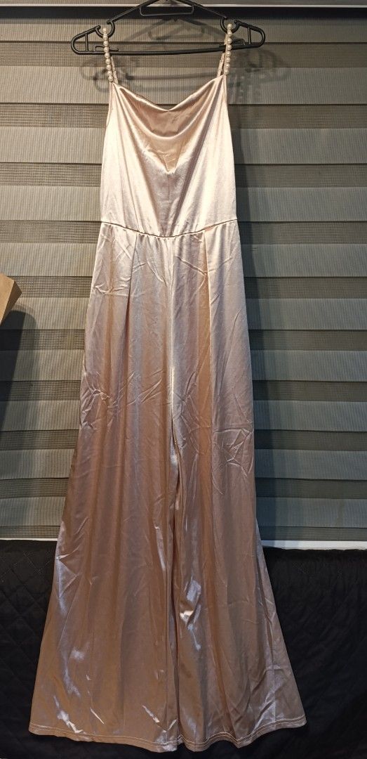 Shein Pearl Strap Satin Jumpsuit Size S (Category: Jumpsuits) located in Manila. Submitted by yunicool (Listing ID 1465687970, Image 1). Description: - Brand: Shein - Size: S (tag attached) - Color: Champagne Pink - Material: Smooth satin with a slight sheen - Design: Spaghetti straps with faux pearl details, cowl neckline, and wide-leg cut - Condition: Brand new with tags.