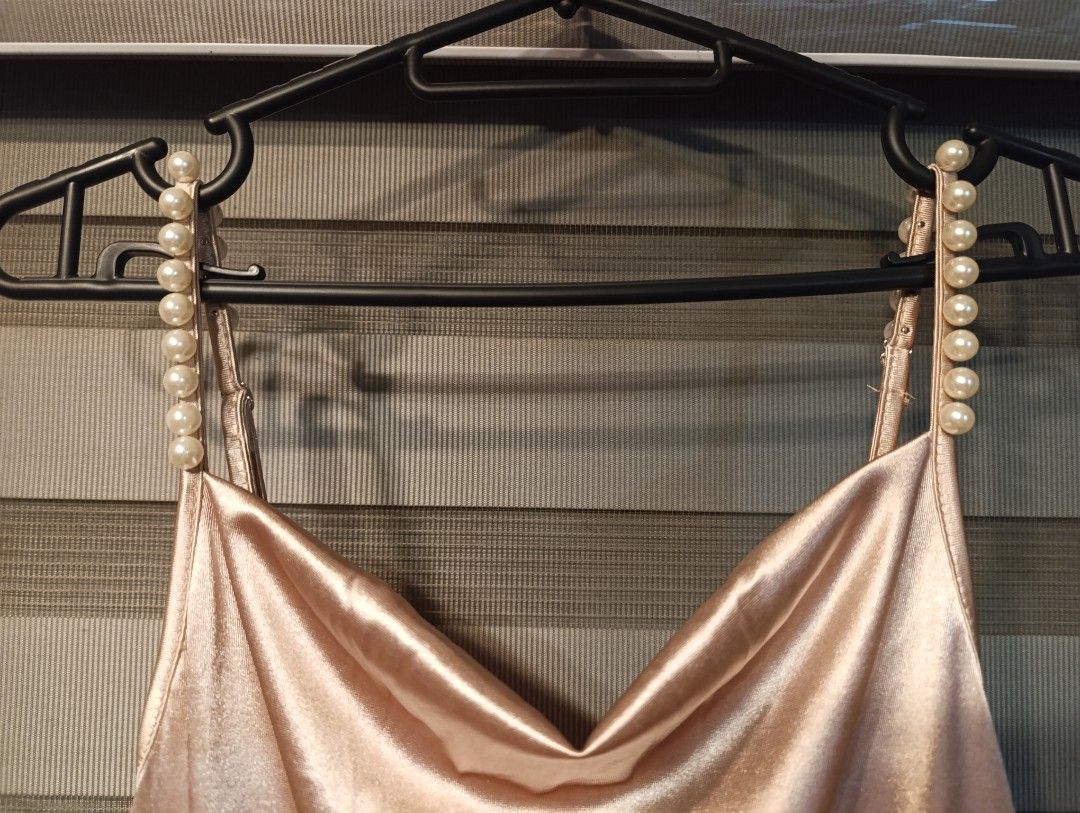Shein Pearl Strap Satin Jumpsuit Size S (Category: Jumpsuits) located in Manila. Submitted by yunicool (Listing ID 1465687970, Image 2). Description: - Brand: Shein - Size: S (tag attached) - Color: Champagne Pink - Material: Smooth satin with a slight sheen - Design: Spaghetti straps with faux pearl details, cowl neckline, and wide-leg cut - Condition: Brand new with tags.